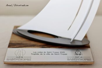 Gros plan sur les finitions et la plaque officielle du Trophée de la Ville et du Port de Saint-Tropez 2025. Zoom sur la plaque gravée officielle du Trophée de la Ville de Saint-Tropez 2025 en acier et socle en bois par Octo Art Audio.
